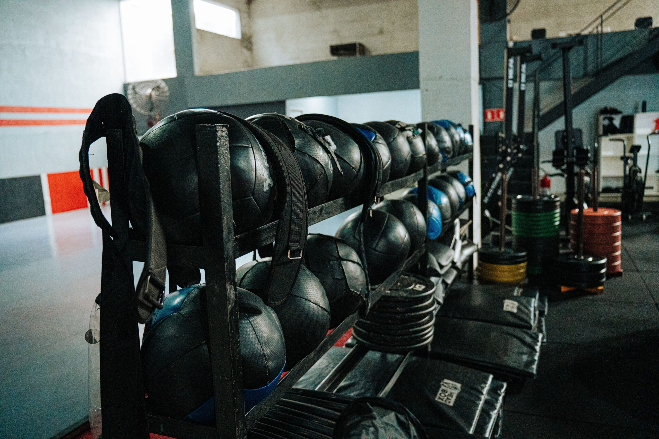 Home Well-equipped indoor gym featuring kettlebells, weights, and workout gear, perfect for fitness enthusiasts.
