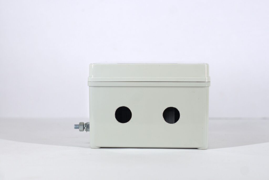 Close-up of a white industrial electrical box with bolt on plain background.