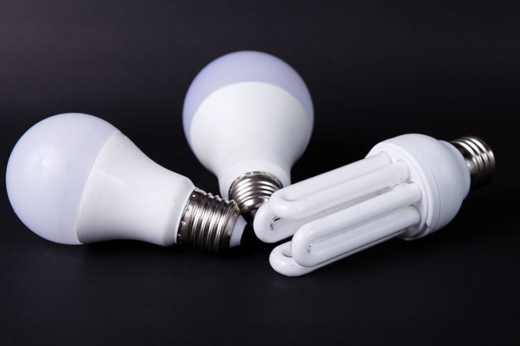 Close-up of energy-efficient LED and CFL light bulbs on black background.